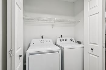 A small laundry room with a washer and dryer.